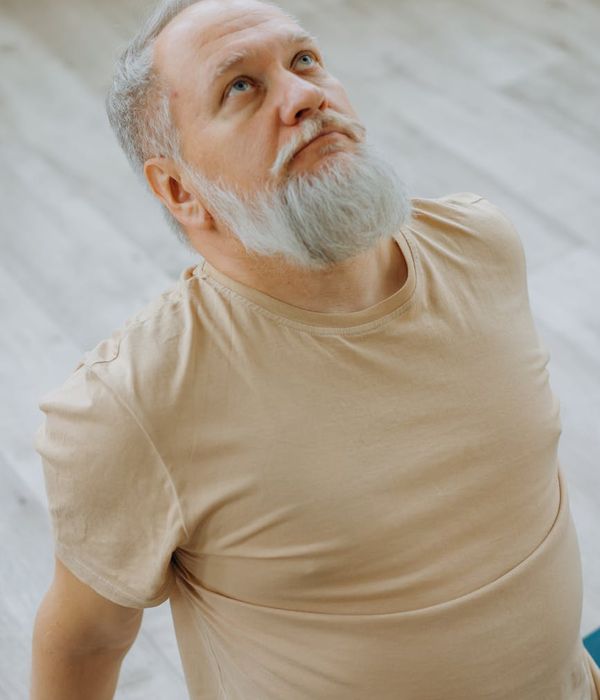 Man in a focused stretching pose enhancing his flexibility.